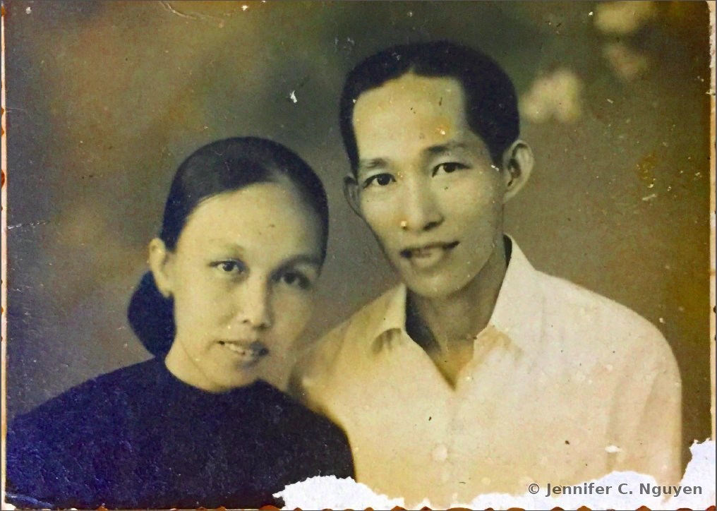 Original sepia-toned archival photograph of a man and woman posing closely together for a portrait, with torn, worn, and ragged edges along the borders of the print