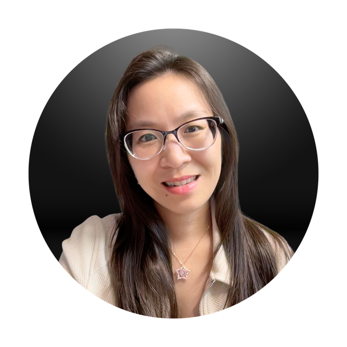 Photo of Jennifer C. Nguyen, headshot with dark background, wearing glasses and a cream sweater