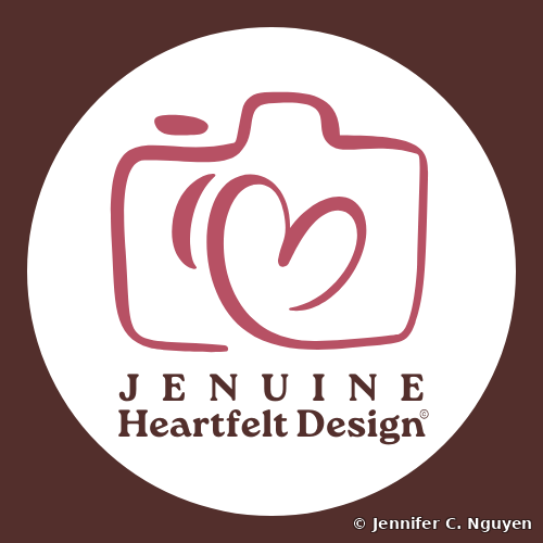 Jenuine Heartfelt Design logo, a rose pink line-art camera icon with a small heart-shaped swirl in place of the lens, paired with the wordmark Jenuine Heartfelt Design in dark maroon serif and bold serif type, set inside a white circle on a deep maroon background