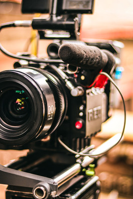 Close-up of a professional video camera rig with lens and microphone