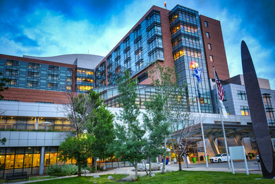 Modern hospital building exterior with glass and brick facade at dusk